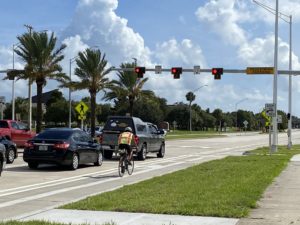 Cyclist approaching a Red pedestrian flashing beacon