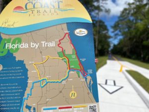 the sign for the Coast to Coast trail that depicts a map of the loop. The Gobblers Lodge Trail is in the background