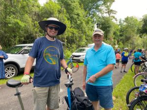 Jason Aufdenberg with his bicycle and Bob Storke smiling for the camera