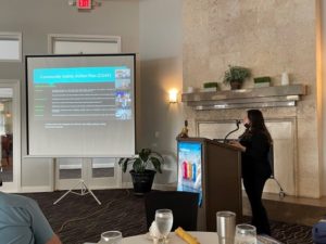 Pamela Blankenship standing at a podium giving a presentation