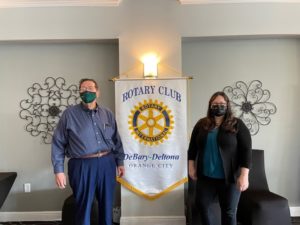 Pam Blankenship and the President of the Rotary CLub standing in front of the Rotary sign