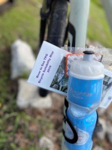 a water bottle with the River to Sea TPO 2019 Bicycle Suitability Map attached to a bicycle